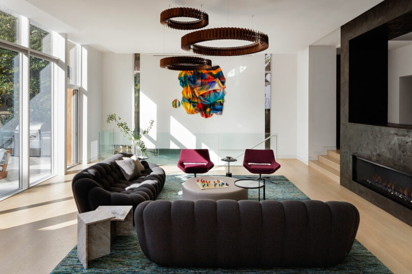 Modern living room with elegant furniture and colorful artwork.