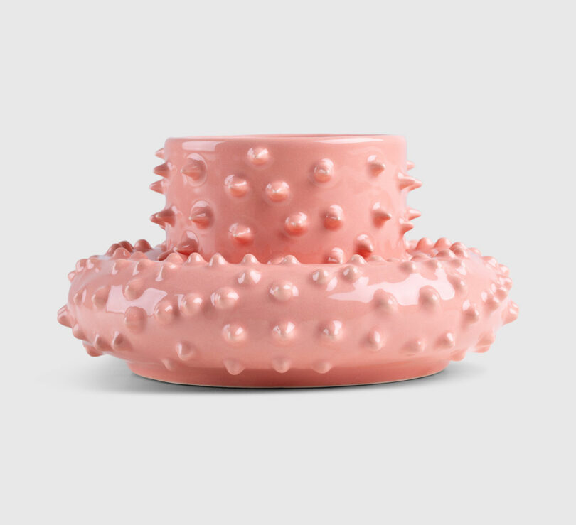pink spiky ceramic cup sitting on its matching saucer