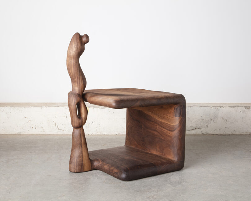 A sculpted wooden bedside table.