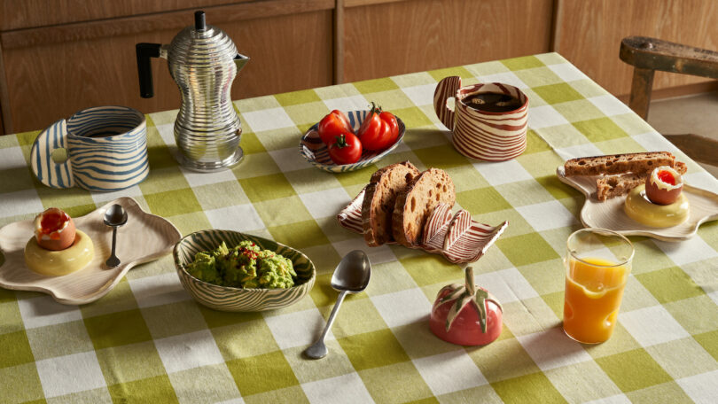 Henry Holland Studio's Breakfast Collection displayed on a table with a green plaid table cloth and breakfast foods