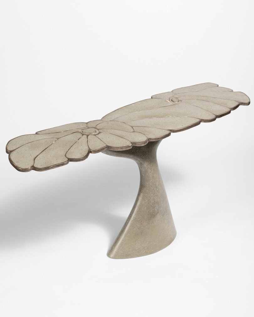 James De Wulf concrete table designed with a flower petal top and a tapered base.