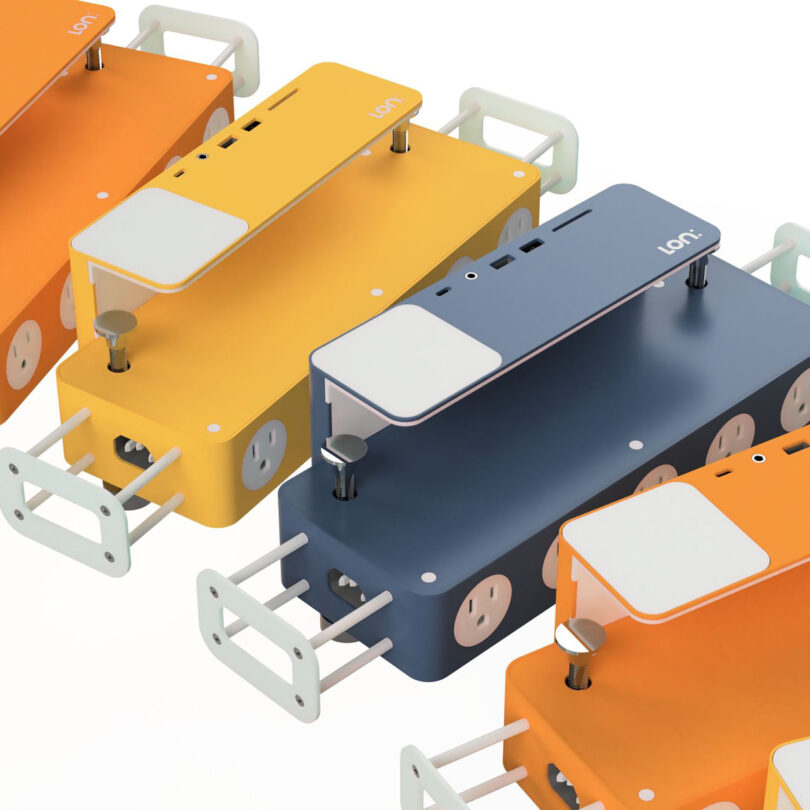An array of colorful arc of Lon:HUB docking stations in orange, yellow, and dark blue color finishes.