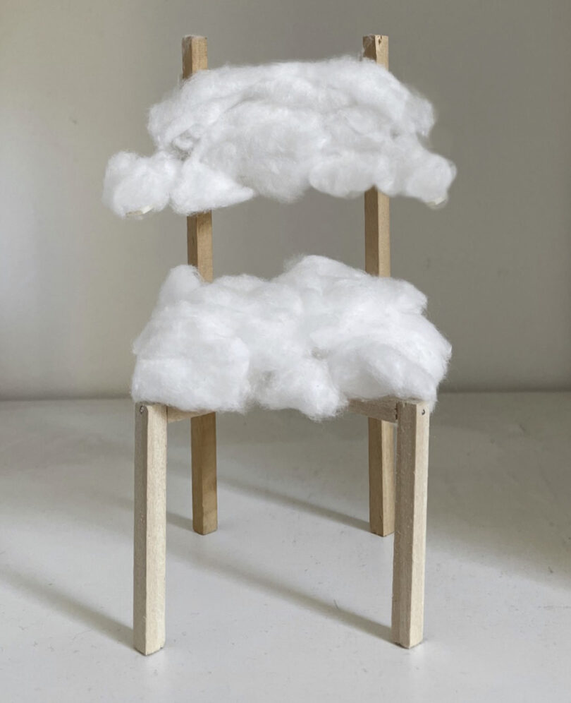 Chair concept mockup using cottony clouds as the seat and backrest of a wooden structure.