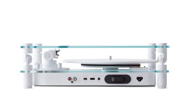 Modern transparent turntable with a minimalist design isolated on a white background from side and back view, with ports visible.