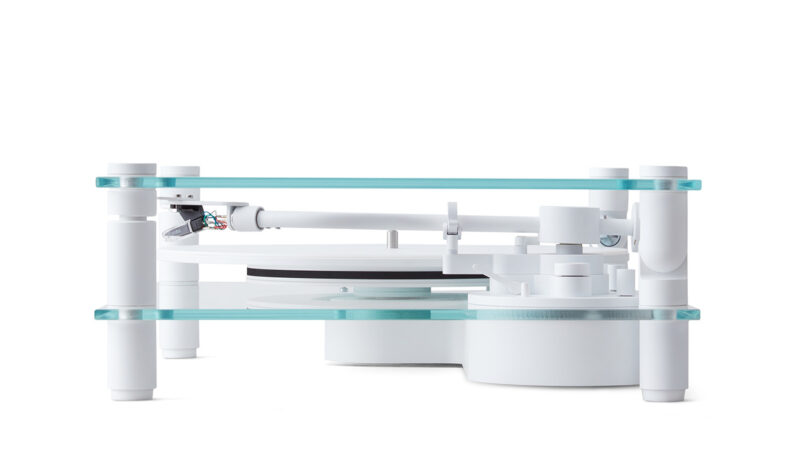 Modern minimalist transparent turntable with all white aluminum tonearm and glass plinth and cover from side view angle.