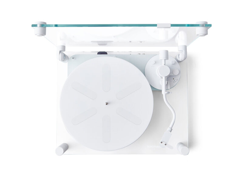 Overhead view of a modern, minimalist transparent turntable with a transparent dust cover wide open