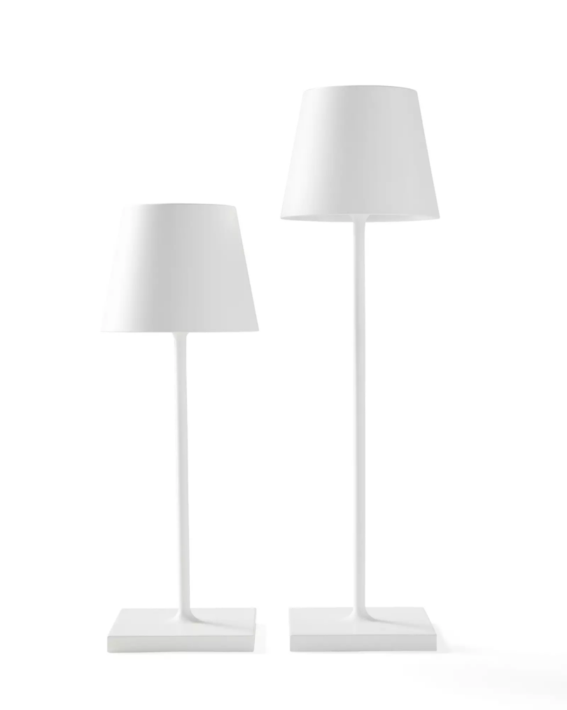 Two white modern outdoor table lamps of different heights.