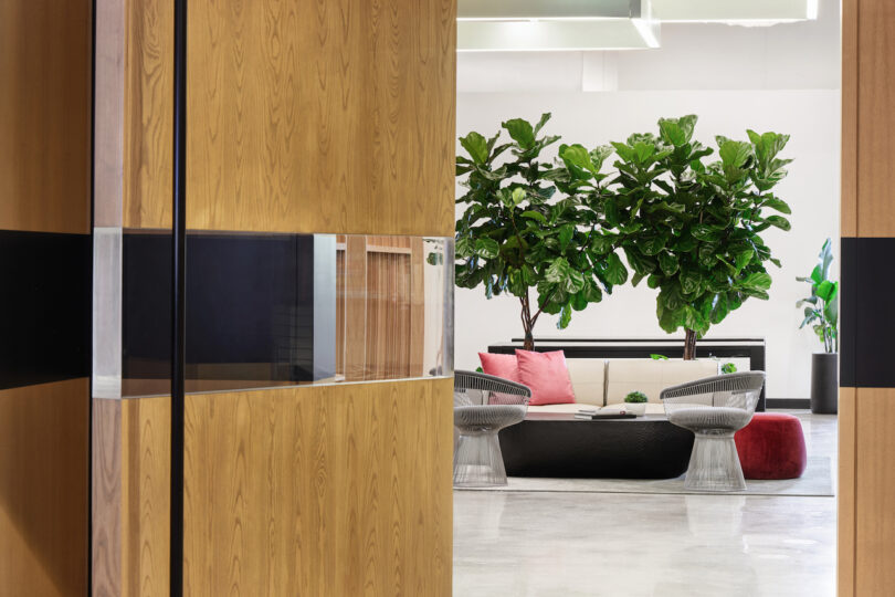 view of office lobby with green trees and seating area