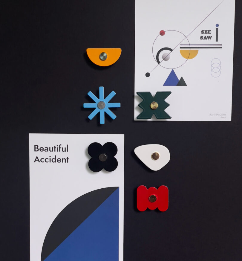 assorted magnets resembling flowers and different shapes on a black table