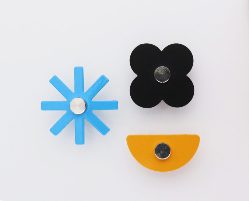 assorted magnets resembling flowers and different shapes on a white table
