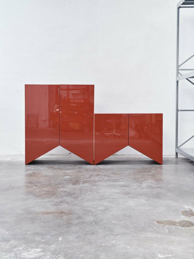 two red cabinets with angular bases