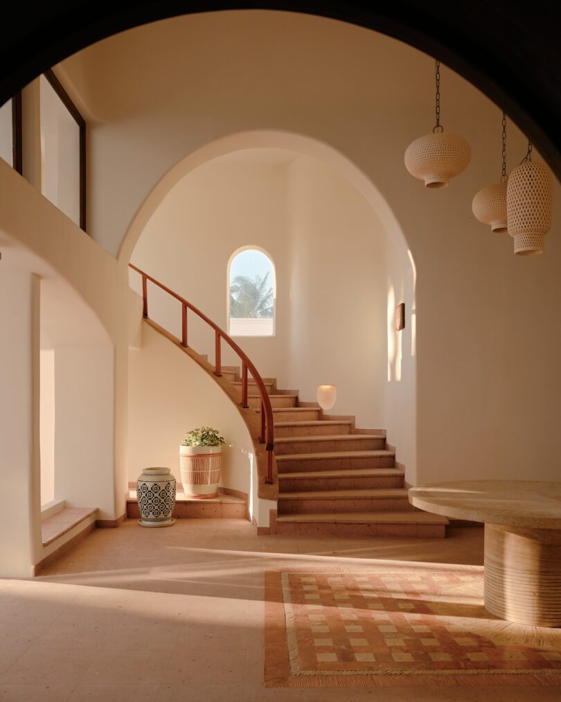 Dramatic curved staircase with archway