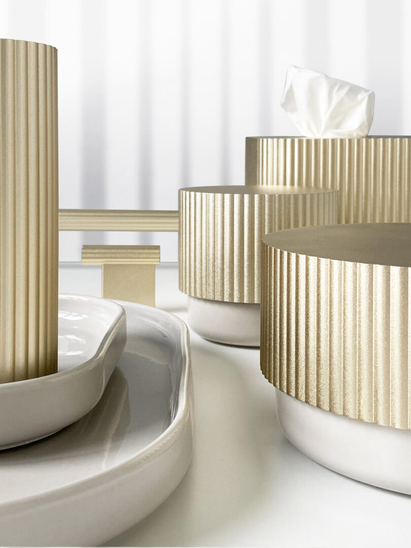 bathroom accessories with a golden top and porcelain bottom on a table