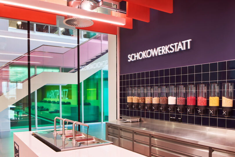 Modern chocolate workshop interior with colorful ingredients on display and vibrant design elements.
