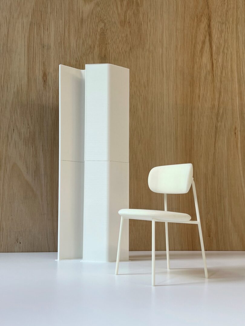 prototype of an acoustic light next to a white chair