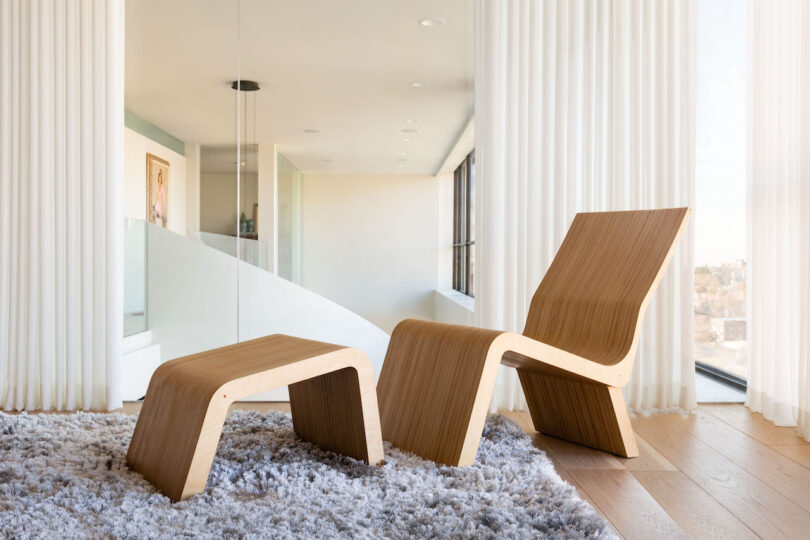 wood chair with matching wood ottoman in minimalist living room