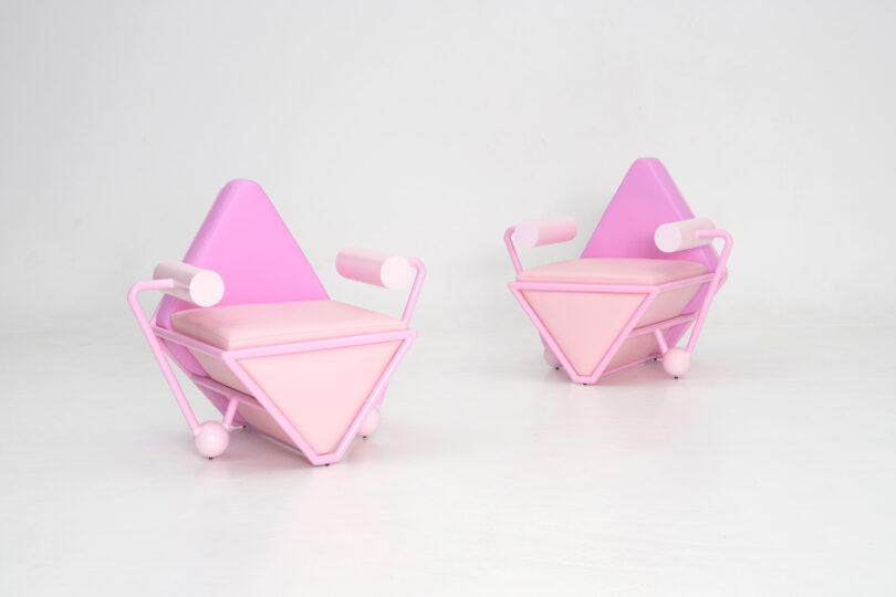 two pink geometric chairs in a white room