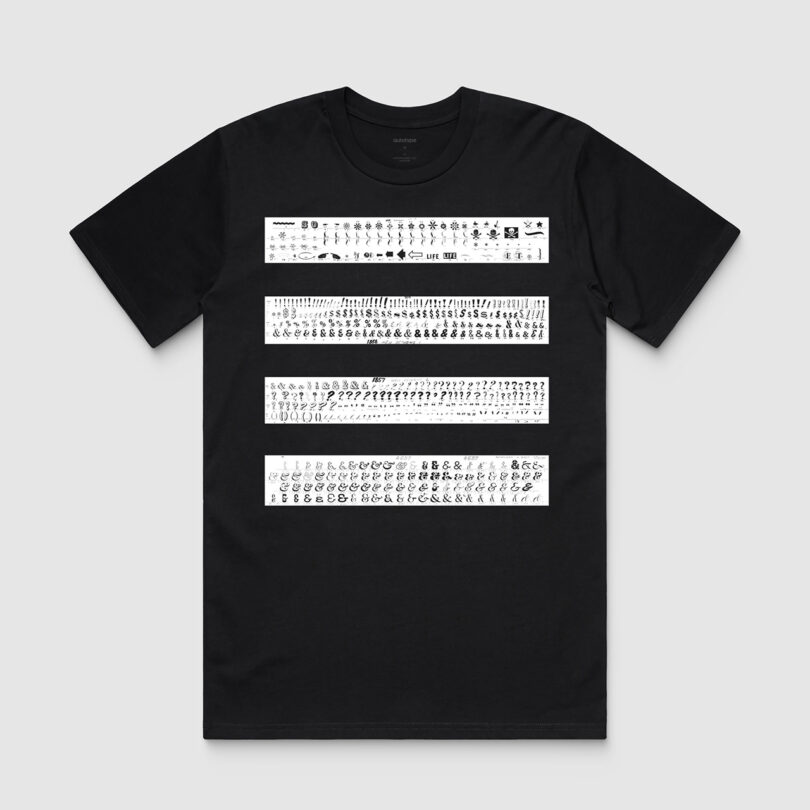 Black t-shirt with three horizontal bands of white typography symbols printed across the chest.