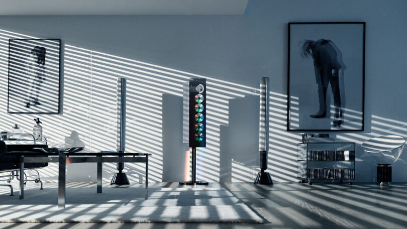 Beosystem 9000c audio system in room with light and shadows cast through blinds across a nearby wall adorned with large format black and white photographs.