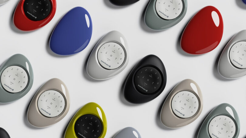 Multiple stone-shaped PowerView Pebble Remote in various colors arranged on a white surface.