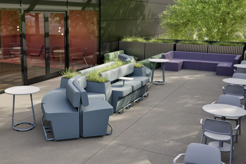 Outdoor seating area with moderm modern furniture, including blue and purple sofas with integrated planters, round tables, and gray chairs.