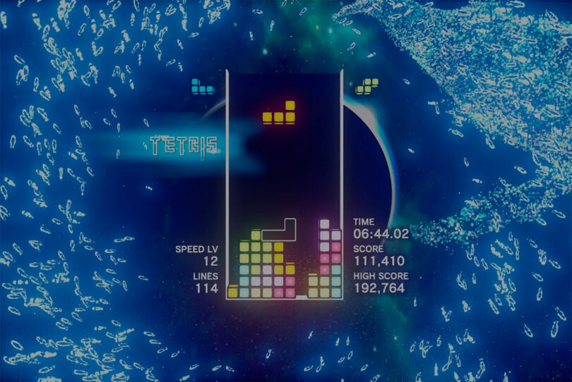 A screenshot from a Tetris video game showing multicolored tetrominoes stacked in a vertical play area. The current score is 111,410 and the high score is 192,764 with a time of 06:44.02.