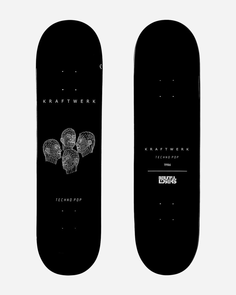 Two black skateboard decks from the Kraftwerk Collection. One deck features four sketched heads with the text "Kraftwerk Techno Pop." The other deck has similar text and reads "1986 Skateboard Limited Edition.