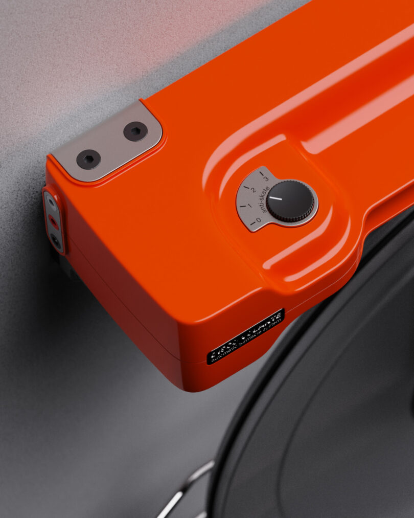 Close-up of an orange wall mounted turntable anti-skate control dial.