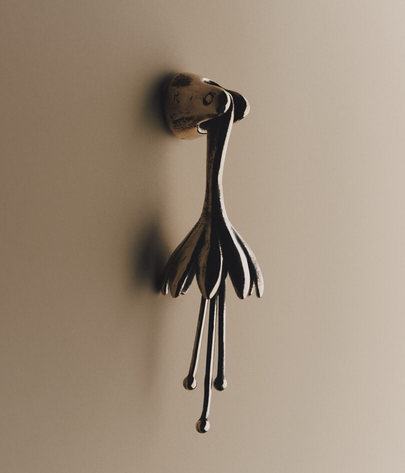 A cabinet pull resembling a flower with elongated petals and stamens.
