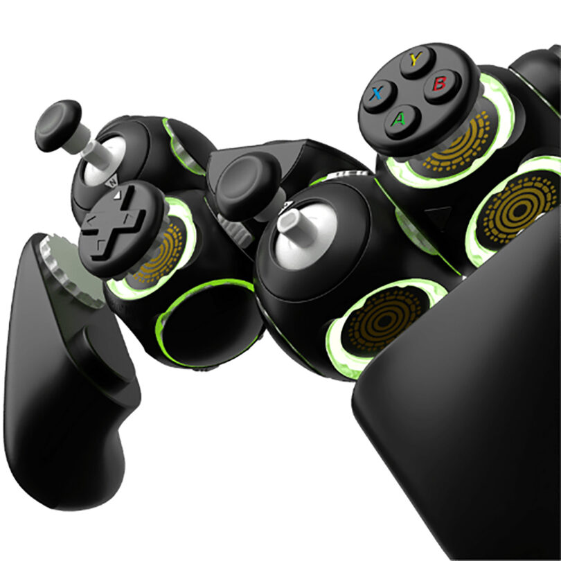 Close-up of a blown up view of modular black and green Proteus gaming controller with spherical module blocks and joystick components detached from their slots.
