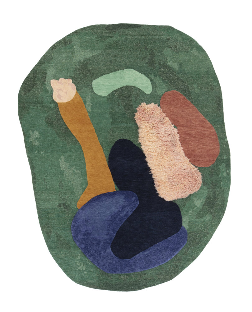 Abstract rug with irregular shape, featuring overlapping patches of green, navy, orange, and pink.