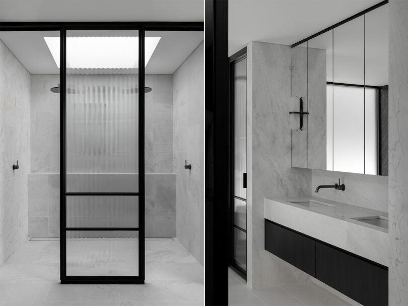 Minimalist bathroom with marble walls and floors, featuring a large shower with glass door and black frame, alongside a sleek vanity with a black base and white countertop, and mirrored cabinets above.