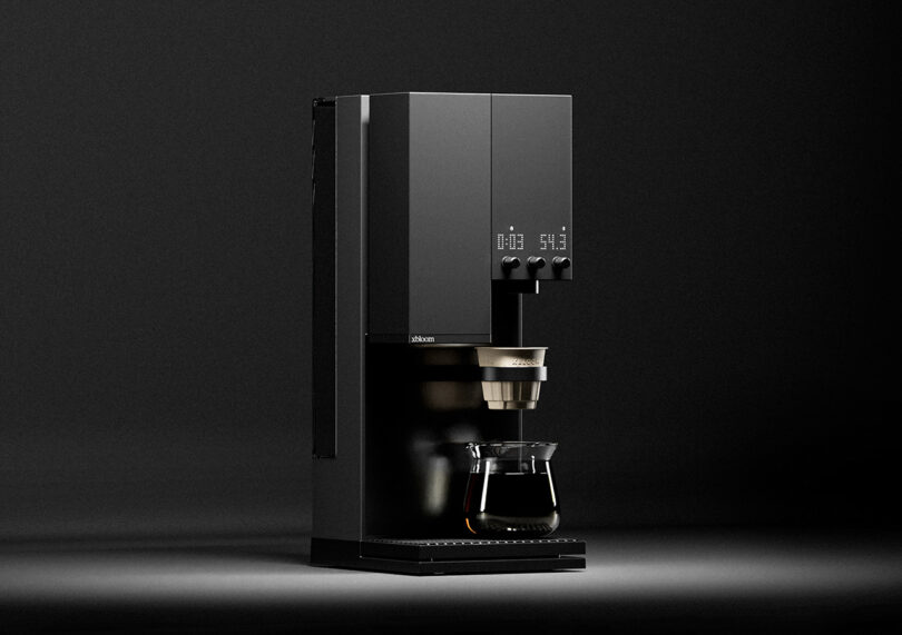 Modern xBloom Studio coffee maker with a carafe, against a dark gray background.