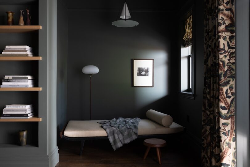 A dark-painted room with a minimalist design.