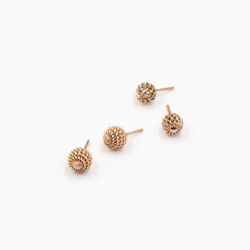 4 gold earrings on a white background