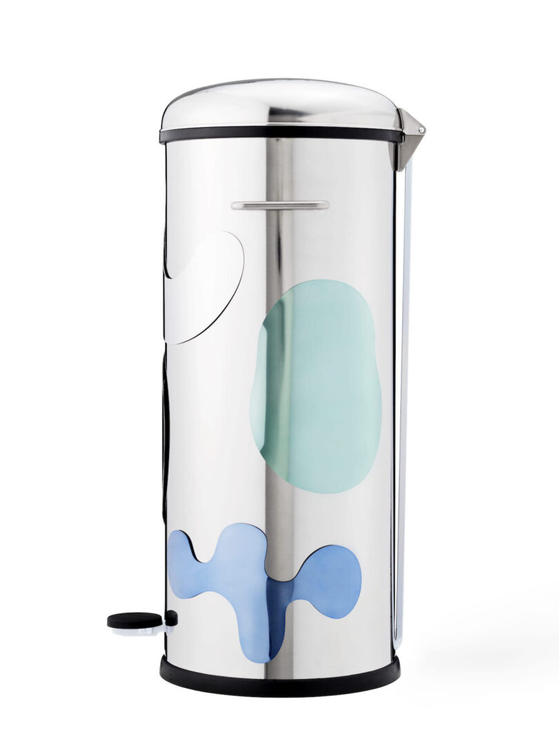tall cylindrical steel trash can with various magnetic shapes attached to it