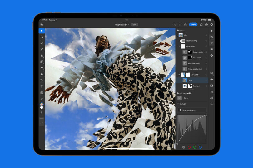 A tablet screen displays an image editing software on an Apple iPad Pro, showcasing a photo of a person wearing patterned pants and a jacket. The photo is being edited with fragmented triangle shapes and color adjustments.