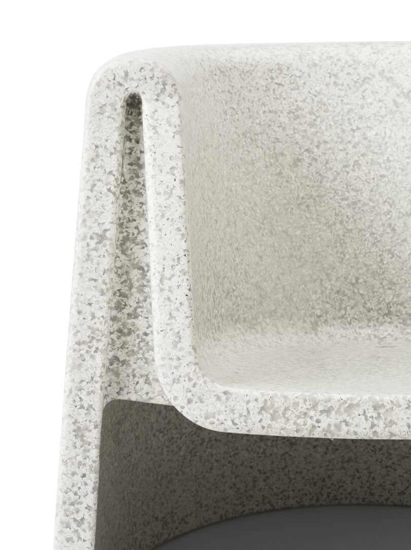 Detail of outdoor white lounge chair against a white background.