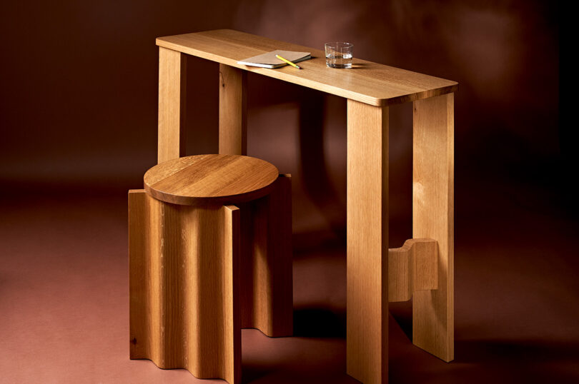 corrugated wood stool in front of narrow consoled table