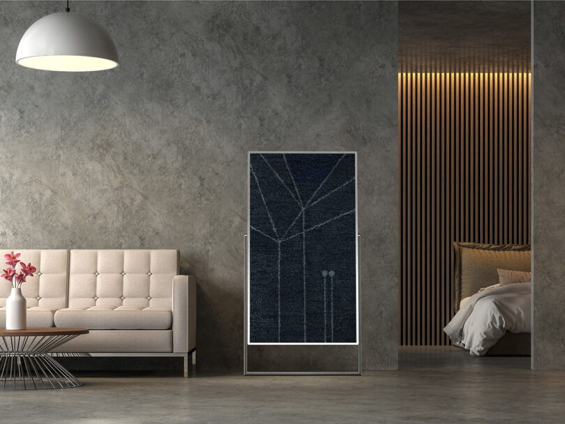 LG FLOW concept 4K television with easel stand shown in a modern living room in vertical art canvas mode