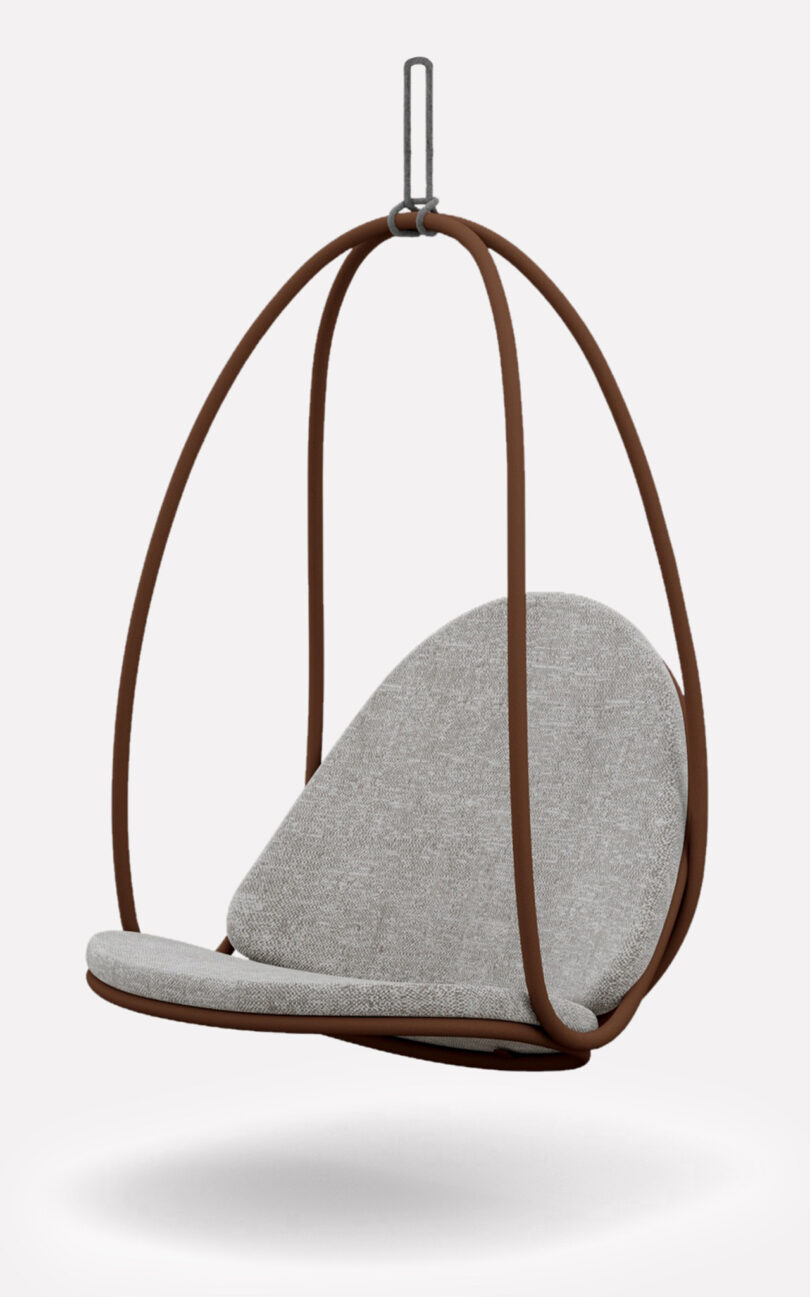A modern, hanging chair with a brown metal frame and light gray cushioned seat, suspended by a hook.