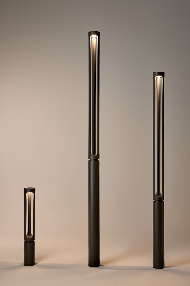 Three modern, cylindrical lamps of varying heights on a neutral background.