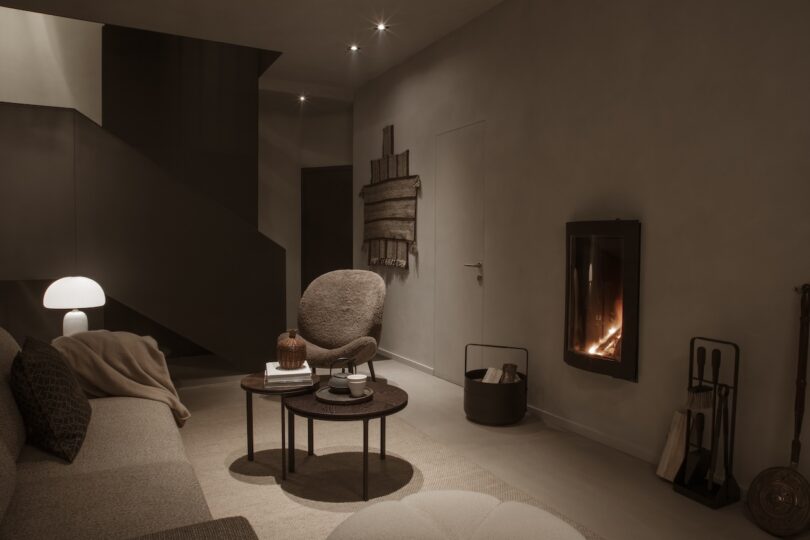 A cozy living room featuring a fireplace and round chair