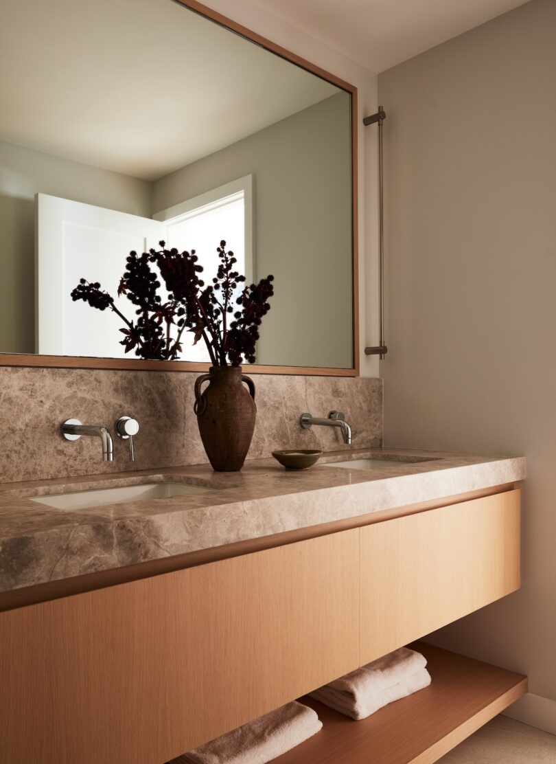 Bathroom vanity with natural stone countertop and minimalist fixtures