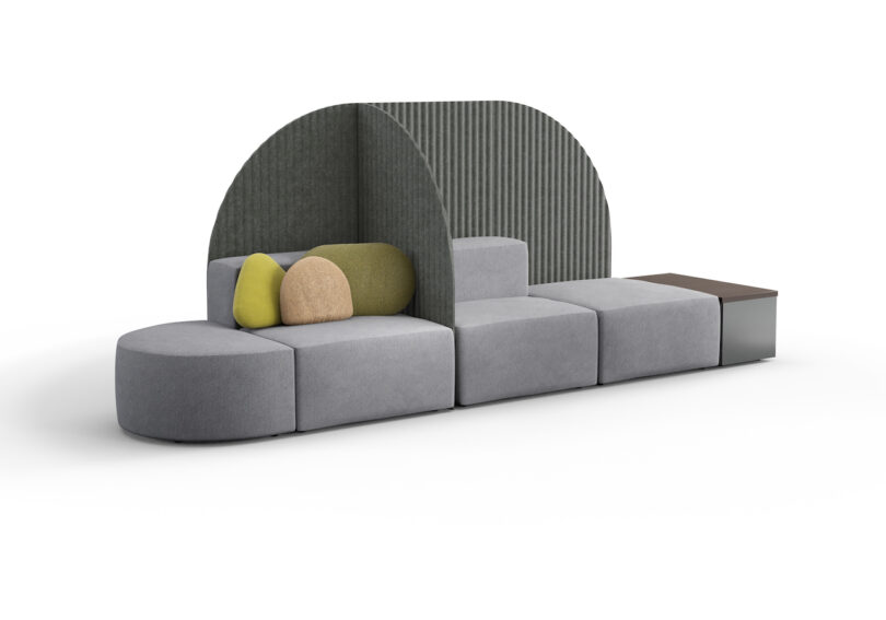 A modular gray and green sofa set with semi-circular high backrests and integrated side table