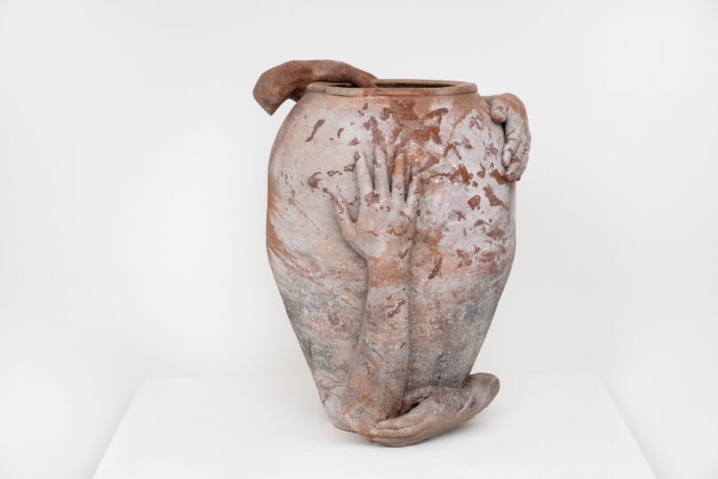 Large clay vessel with 4 sculptures of hands attached