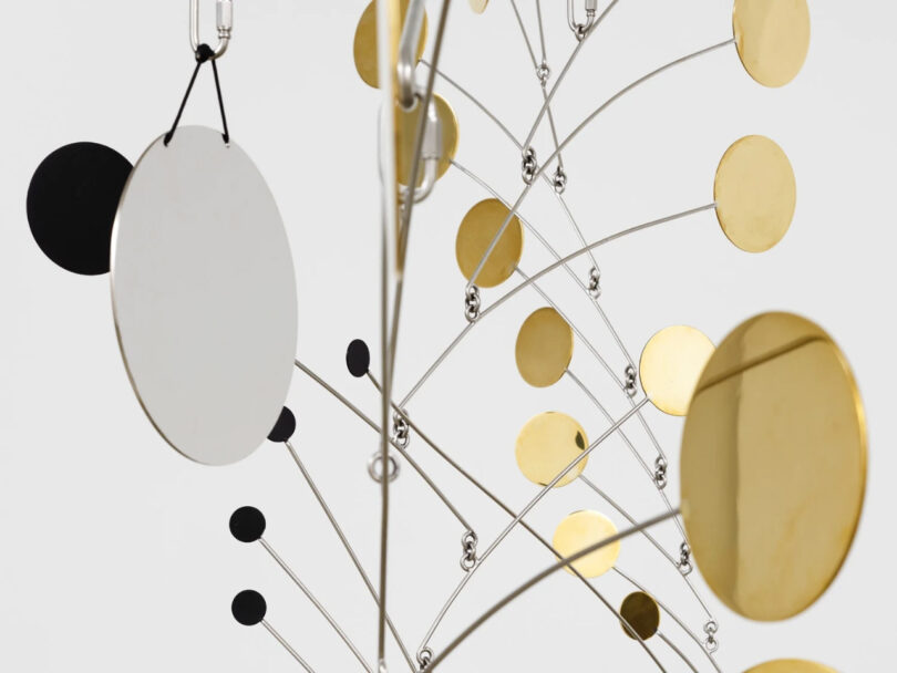 Gold and black circles hanging from supports