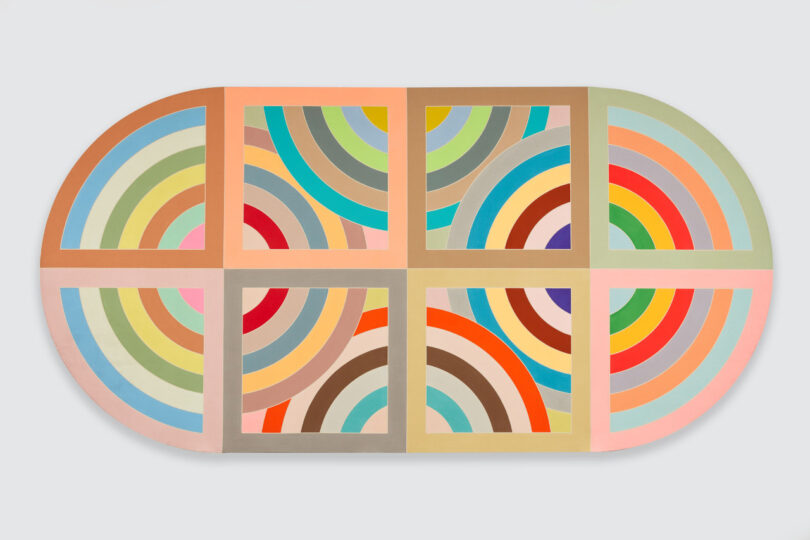 Pill-shaped painting with colorful concentric lines 