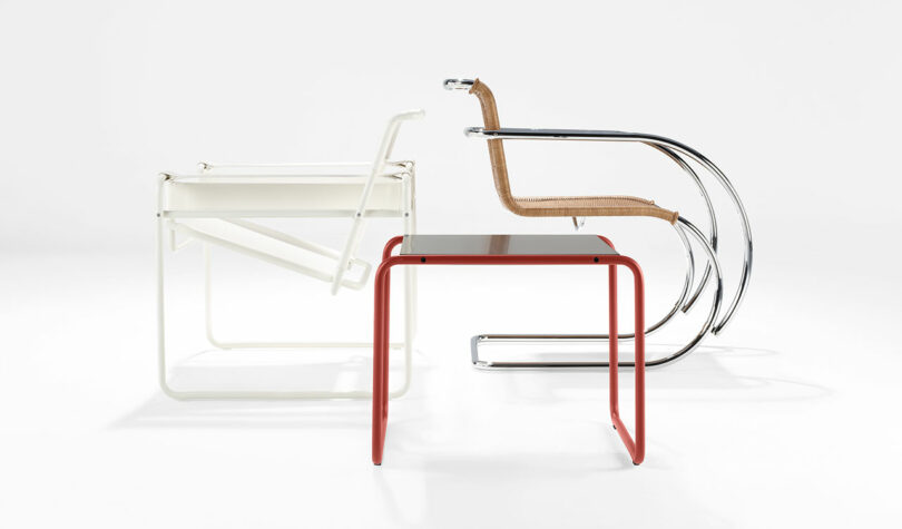 Three modern chairs in a minimalistic setting: one white, one with a chromed frame and woven seat, and a red stool in the foreground. All are displayed against a white background.