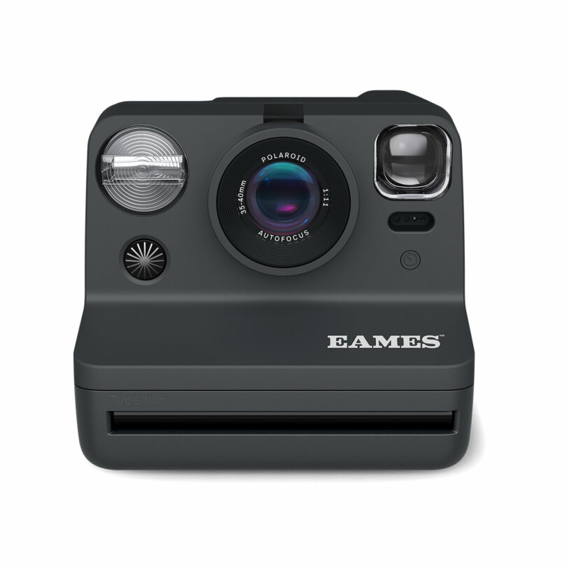 A black Polaroid camera with the word "EAMES" printed on the front. The camera features a lens, flash, and viewfinder.